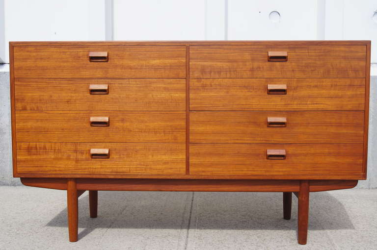 This dresser was designed by Borge Mogensen for Soborg Mobler. It is constructed of teak and features eight spacious drawers with unique teak drawer pulls.