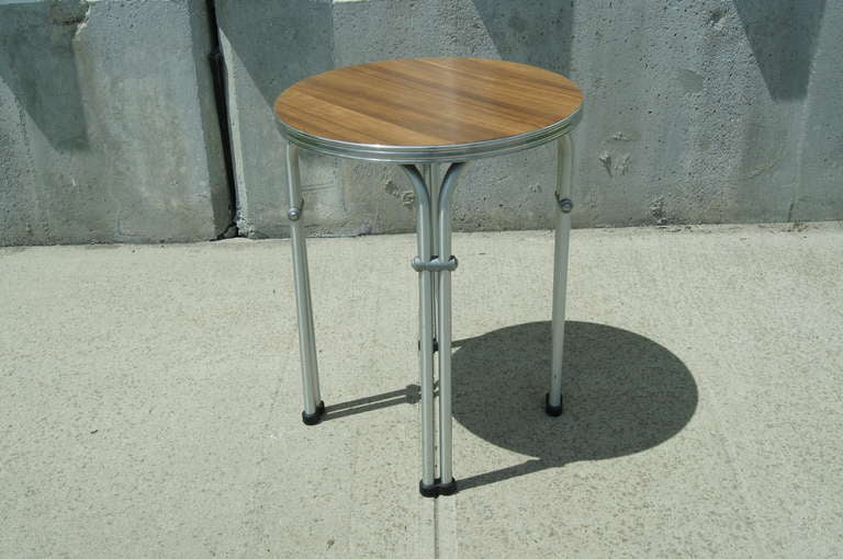 Produced by NAMCO (National Art Metal Company) of Australia, this small side table is constructed of aluminum tubing along the lines of Warren McArthur's patented technique. The arced tubes, which create the effect of doubled legs, give it strength