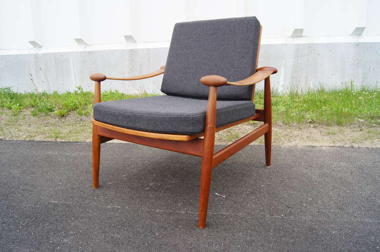 This elegant easy chair has been expertly reupholstered in grey Maharam Hallingdal textile.