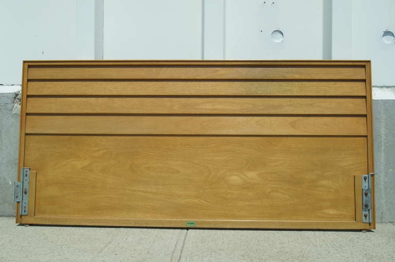 Edward Wormley designed this midcentury headboard for Dunbar. Louvered panels of light mahogany create clean but strong lines that extend the width of a king-size bed.
