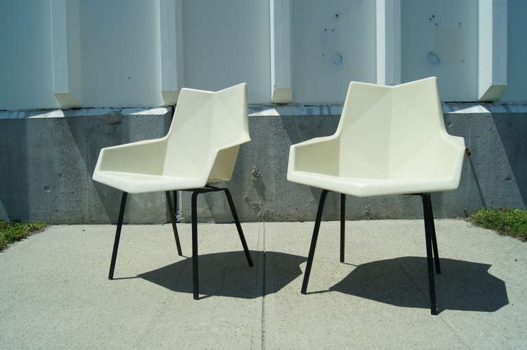 Pair of geometric cream fiberglass armchairs by Paul McCobb with metal base.