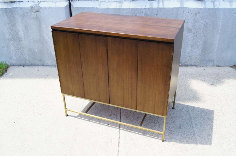 This petite dresser features 4 roomy drawers concealed behind two accordion doors.