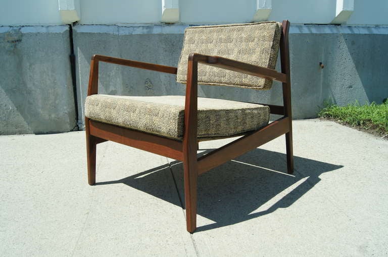 Both stylish and comfortable, this walnut midcentury armchair is Classic Jens Risom. Low and wide, with angled armrests, the proportions are well considered. The seat and snap-on backrest are upholstered in a nubby Knoll textile.