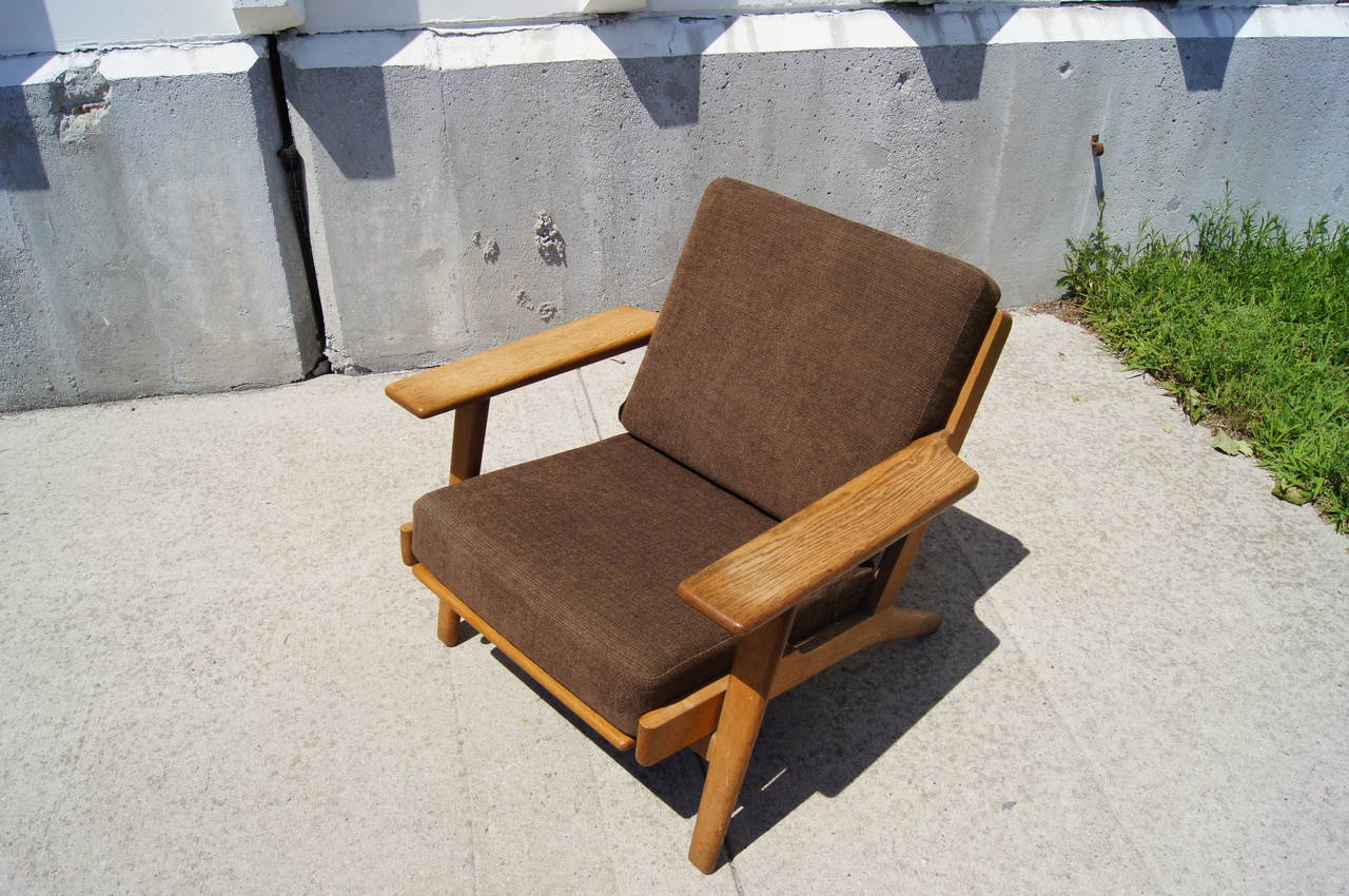 Designed by Hans Wegner for GETAMA in 1953, this low-back lounge chair has a solid oak frame.