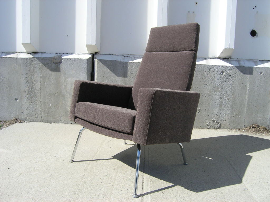 Made in Denmark in the style of Hans Wegner or Arne Jacobsen, this high-back armchair features a comfortable angled seat resting on tubular chrome legs. The chair has been reupholstered in Knoll's Haze textile in the color Peat.