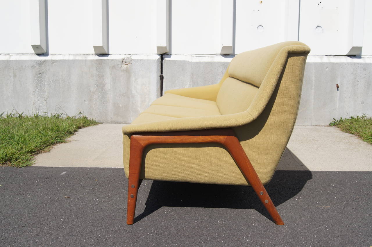 This sofa was designed by Folke Ohlsson and manufactured by Dux. It features a teak frame and a very comfortable and large seat, which has been newly reupholstered in vintage textile.