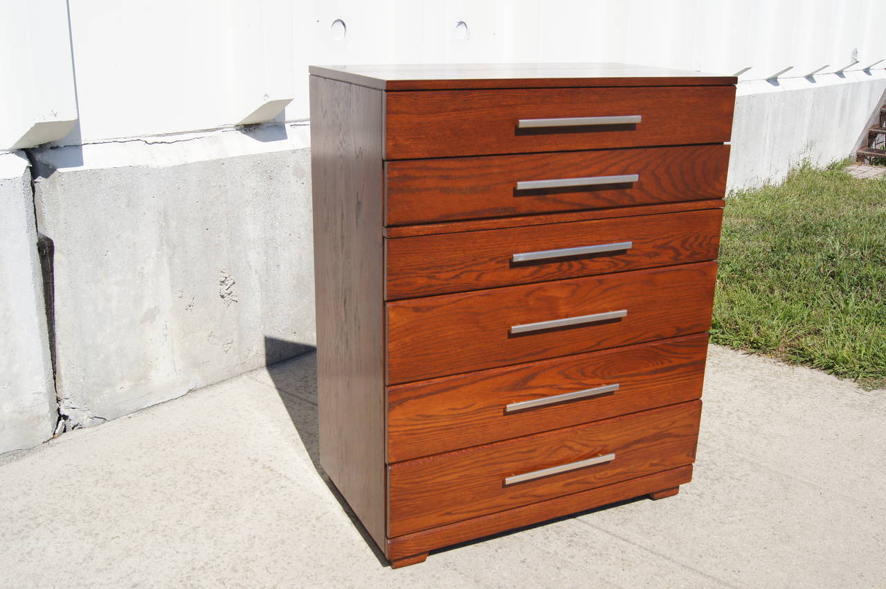 Raymond Loewy designed this clean-lined dresser for the Mengel furniture company. Solidly constructed of a handsomely grained oak, it has six drawers, one of which has two dividers. All the drawers feature the original long aluminum pulls.

A