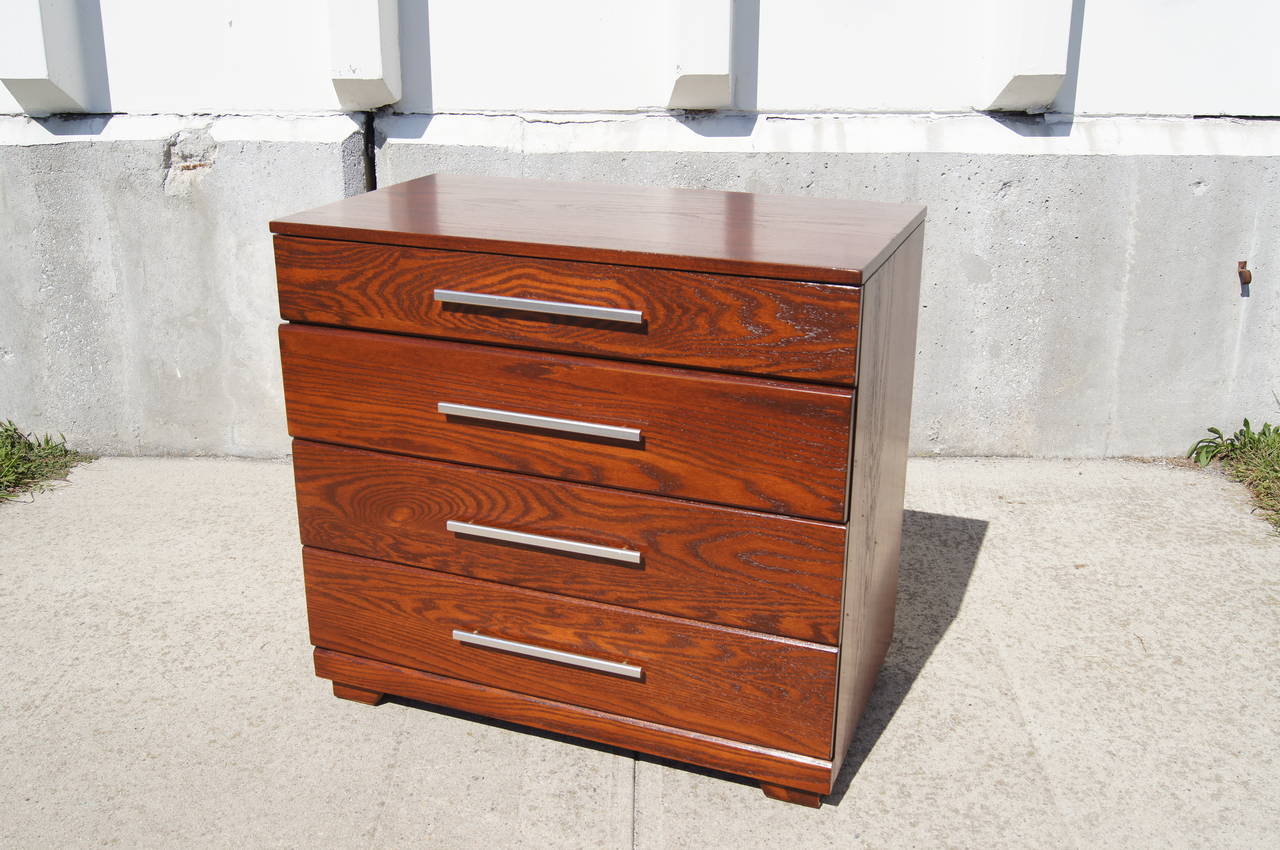 Raymond Loewy designed this clean-lined dresser for the Mengel Furniture Company. Solidly constructed of a handsomely grained oak, it has four drawers that feature the original long aluminum pulls. Label in back.


 