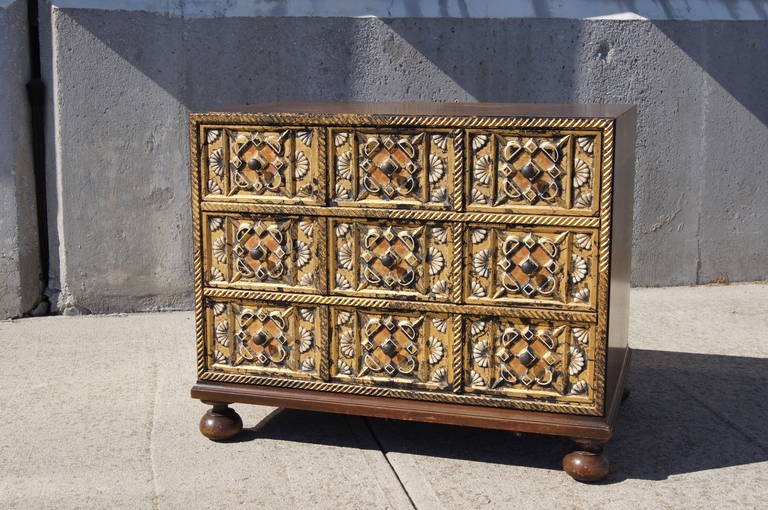 Created by William A. Berkey Furniture Co. for its parent company Widdicomb, this charming small walnut dresser features three drawers with ornately carved, gold-leafed fronts. 