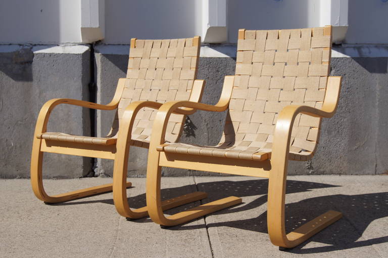 Designed by Alvar Aalto in 1939, this armchair is known as the Pension chair. It is composed of a cantilevered birch plywood frame and a linen webbed seat.