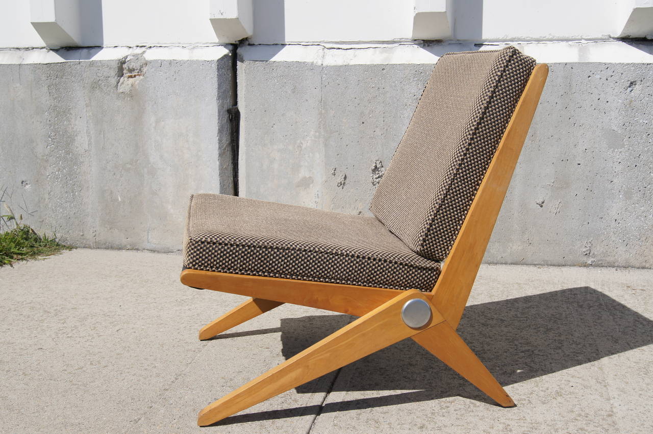 This no. 92 Scissor Chair was designed by Pierre Jeanneret and manufactured by Knoll International in Germany. It is composed of a birch frame with cushions that were previously reupholstered.
