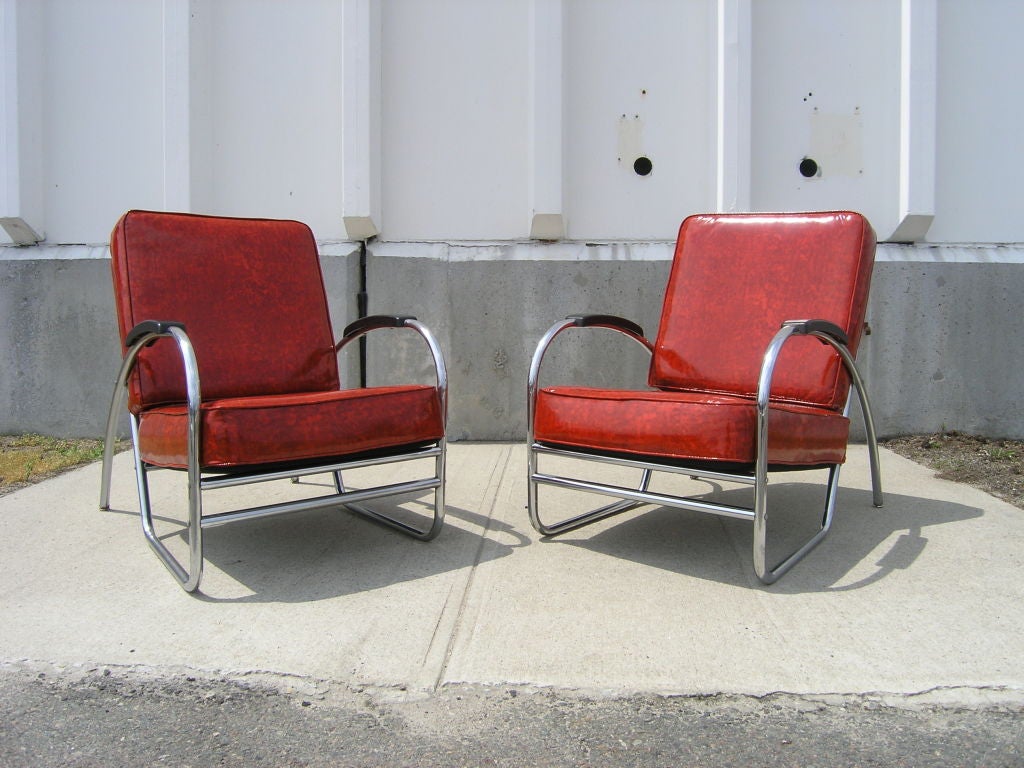 This pair of art deco lounge chairs have been reupholstered in vintage red vinyl.