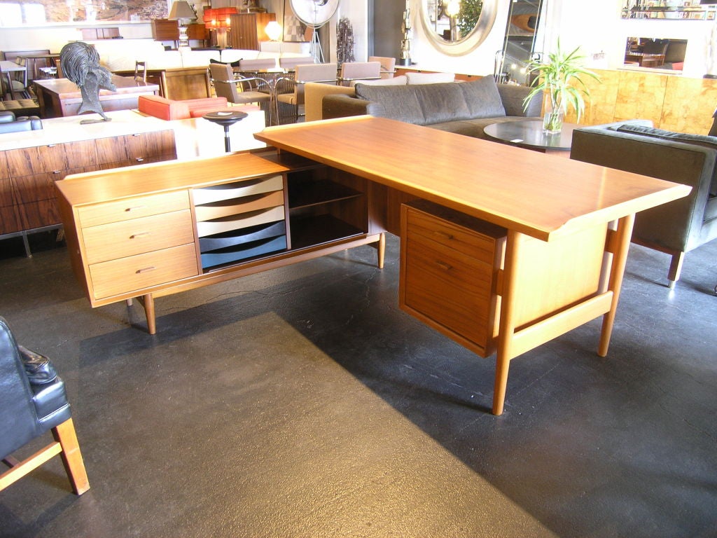 This lovely teak desk has multi-colored slide out drawers as well as a large file drawer and several other drawers and compartments. The credenza does not have a sliding door but all the small drawers are in their original colors.<br />
<br