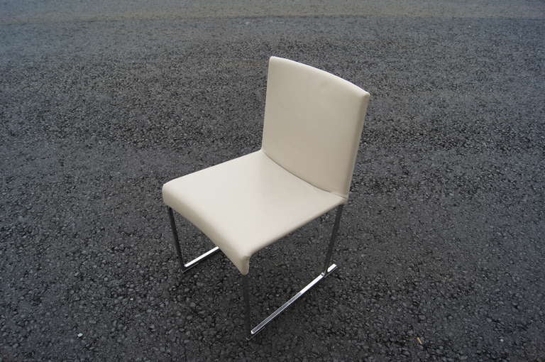 Designed by Antonio Citterio in 1999, the Solo chair model S47 is intended to be a fusion of traditional comfort and modern design. These chairs feature a buttery light stone grey leather seat on a sleek aluminum frame. A total of 20 chairs are