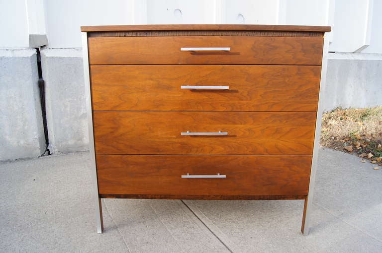 Designed by Paul McCobb and manufactured by Calvin Furniture, this four-drawer dresser features aluminum accents and slender drawer pulls that emphasize its clean lines and beautiful walnut grain.

We also have a corresponding six-drawer dresser.