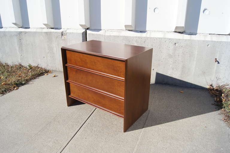 T. H. Robsjohn-Gibbings designed this walnut dresser for Widdicomb. A beveled frame wraps around three deep drawers with long pulls at bottom. The dresser retains its original label. 

We have two dressers available.