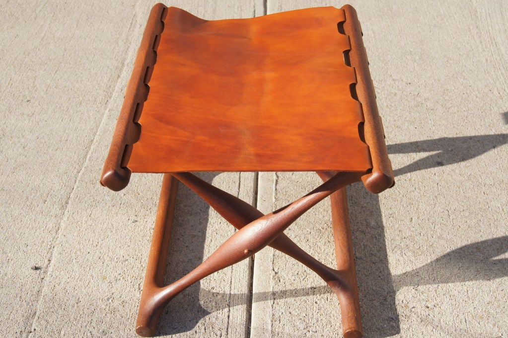 This seat on this elegant folding stool has been expertly replaced with high quality leather. 