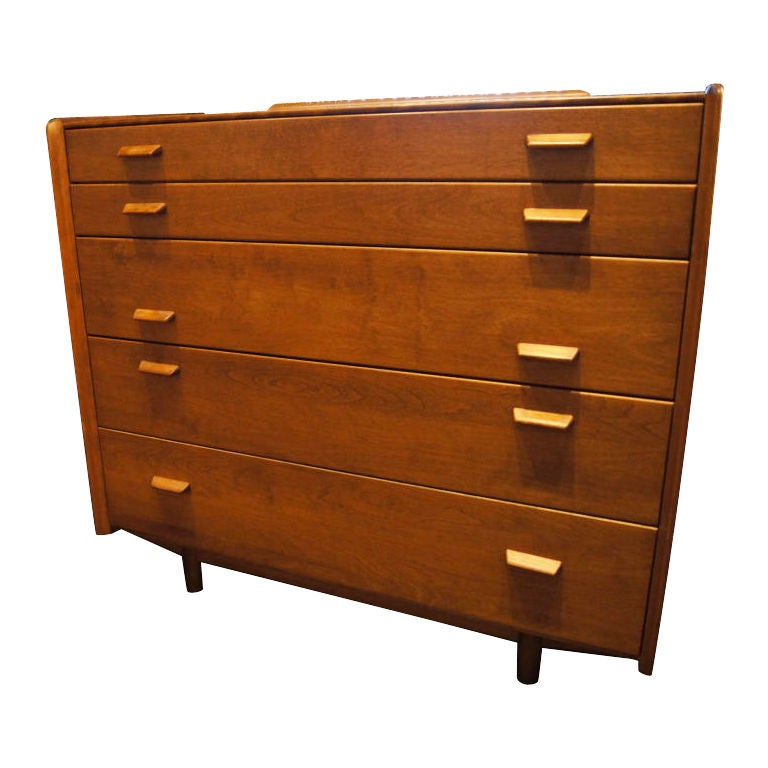 The unique spacing of the pulls on this elegant dresser create a distinct look. Two shallow drawers above three deep drawers provide ample storage space.