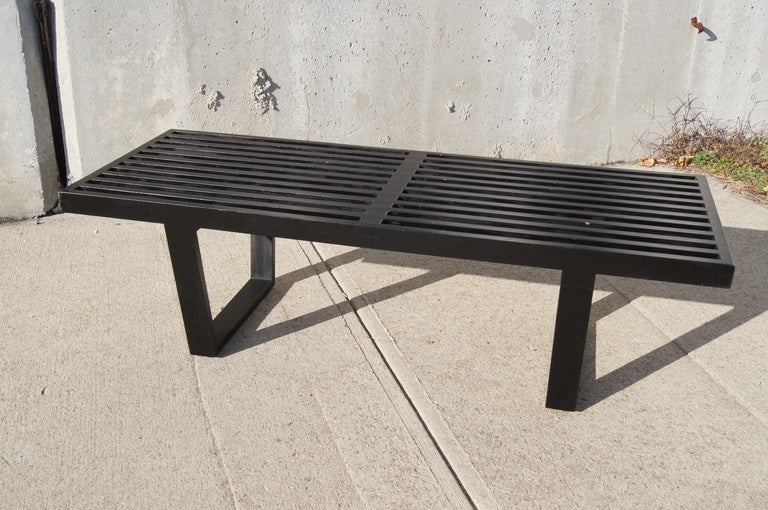 This iconic slat bench by George Nelson for Herman Miller can serve as either seating or as a coffee table. 