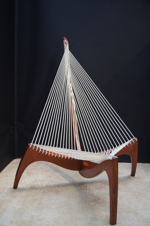 Jorgen Hovelskov designed the iconic Harp Chair in 1968. It is reminiscent of the bow of a Viking ship, and its flag halyard seat provides a unique optical effect.