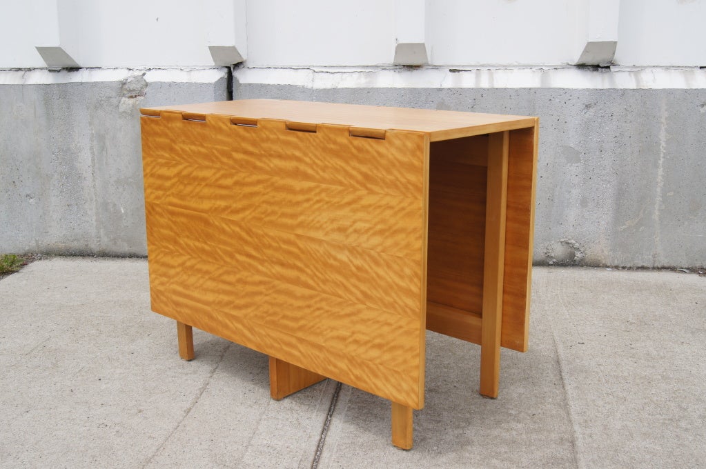 This drop-leaf table is both beautiful and functional. Designed by George Nelson for Herman Miller, it can serve many purposes and was meant to coordinate with other Nelson furniture. This table could serve as a console table when closed, as a work