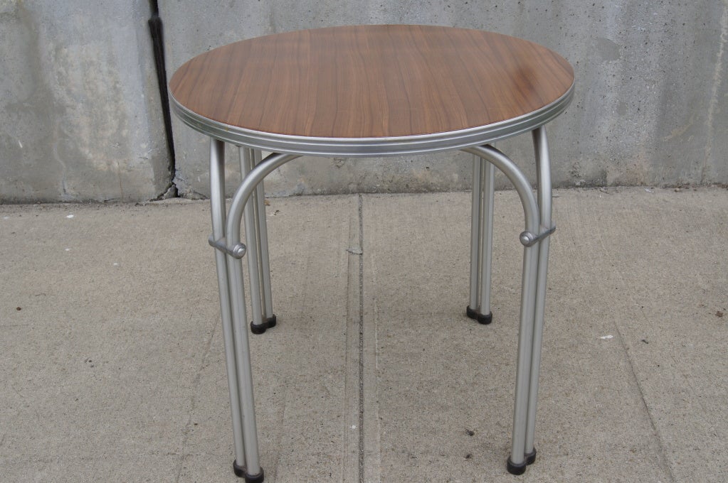 Produced by NAMCO (National Art Metal Company) of Australia, this small side table is constructed of aluminum tubing along the lines of Warren McArthur's patented technique. The arced tubes, which create the effect of doubled legs, give it strength