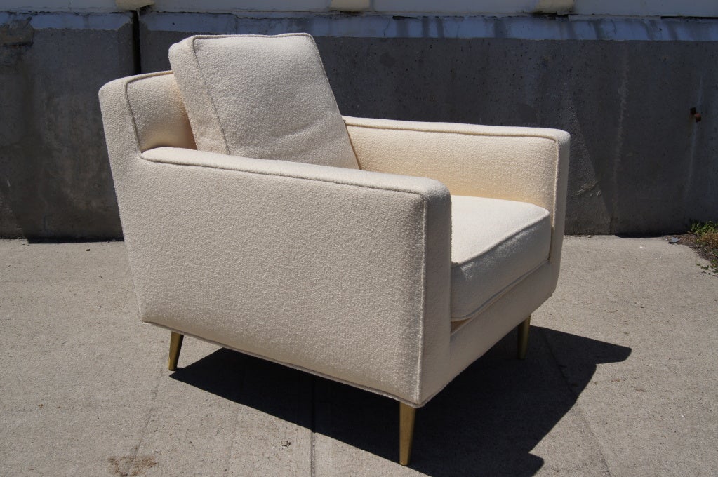 Edward Wormley designed this deep and comfortable club chair for Dunbar in the 1950s. Upholstered in Knoll's pearl-colored Classic bouclé, the chair sits on tapered brass feet.