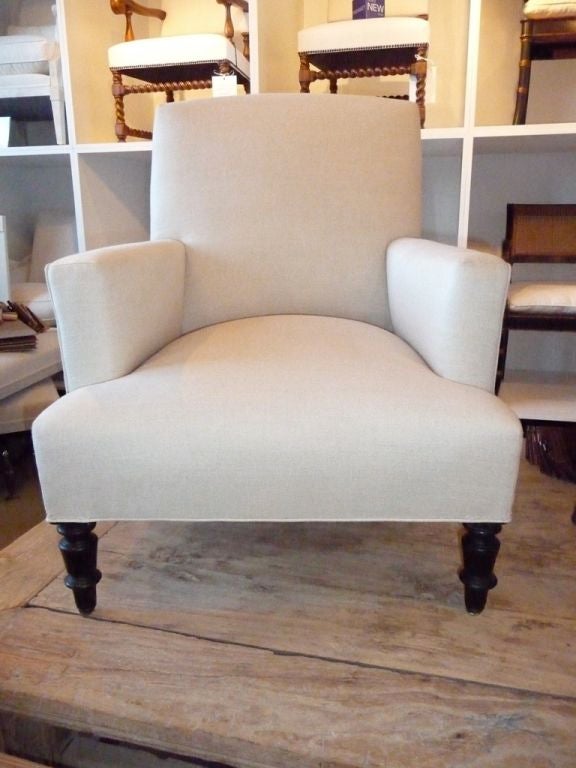 A newly upholstered Napoleon III club chair with ebonized turned legs covered in a Belgium linen.<br />
<br />
33 h x 27 w x 33 d x 15 sh x 20.5 ah