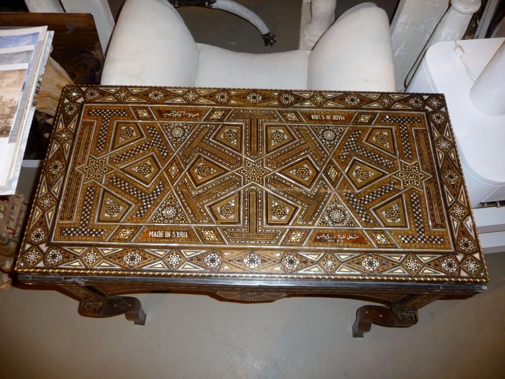 An extraordinary inlaid game table with multiple game boards. Signed and dated, made in Syria. Inlaid with Mother of Pearl.