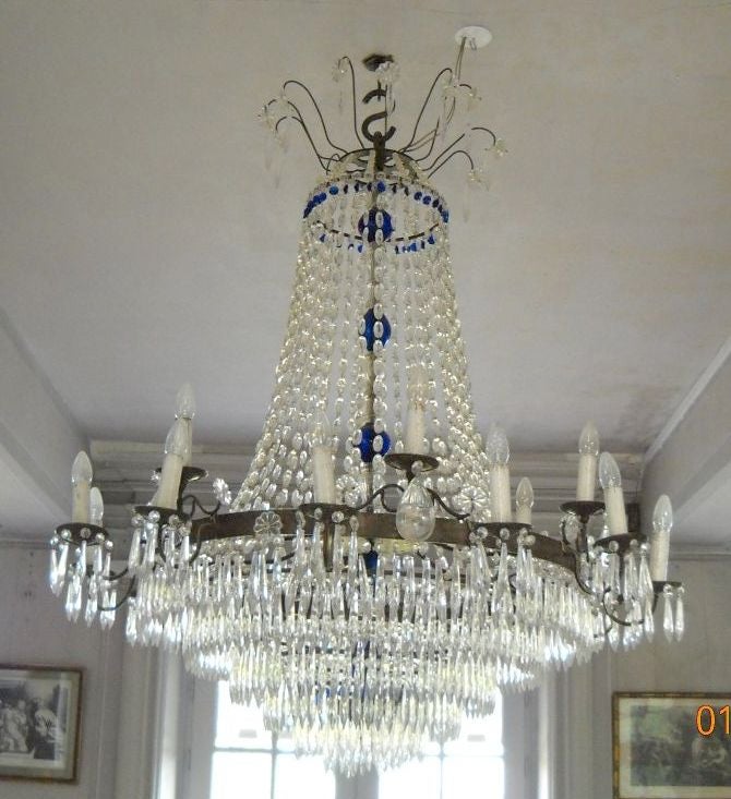 A wonderful large scale iron & crystal chandelier with a cobalt blue stem & drops.