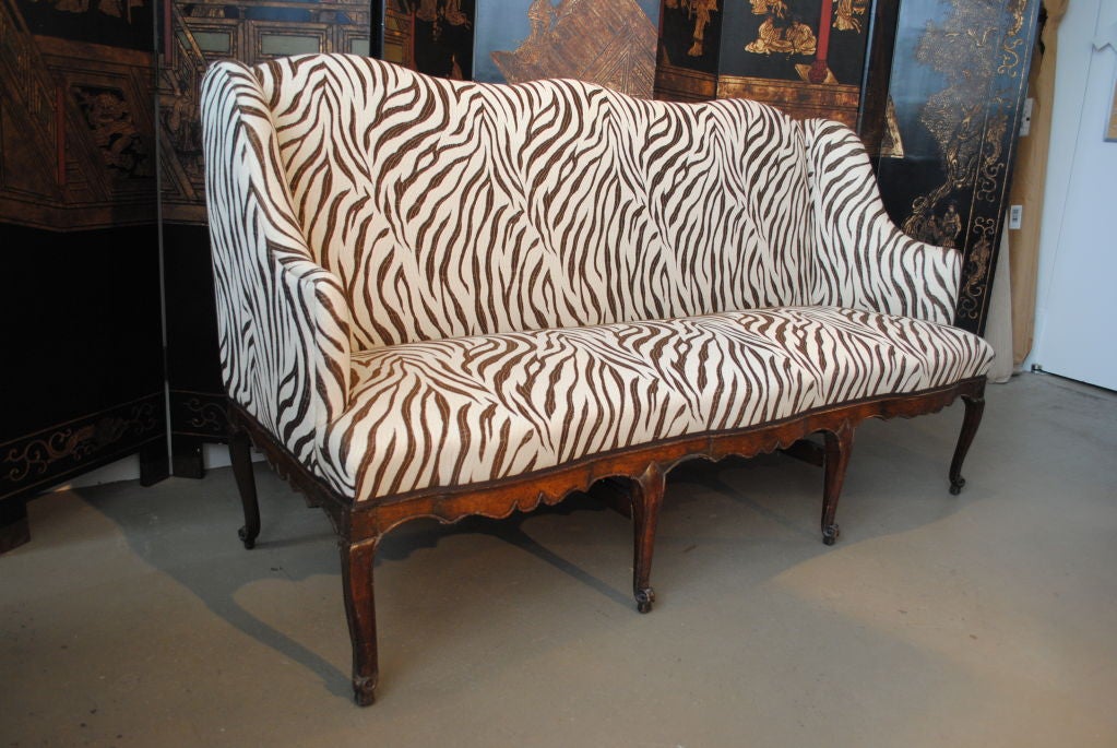 A Louis XV sofa with a serpentine shaped back & seat newly  upholstered in Loro Piana's Safari fabric.