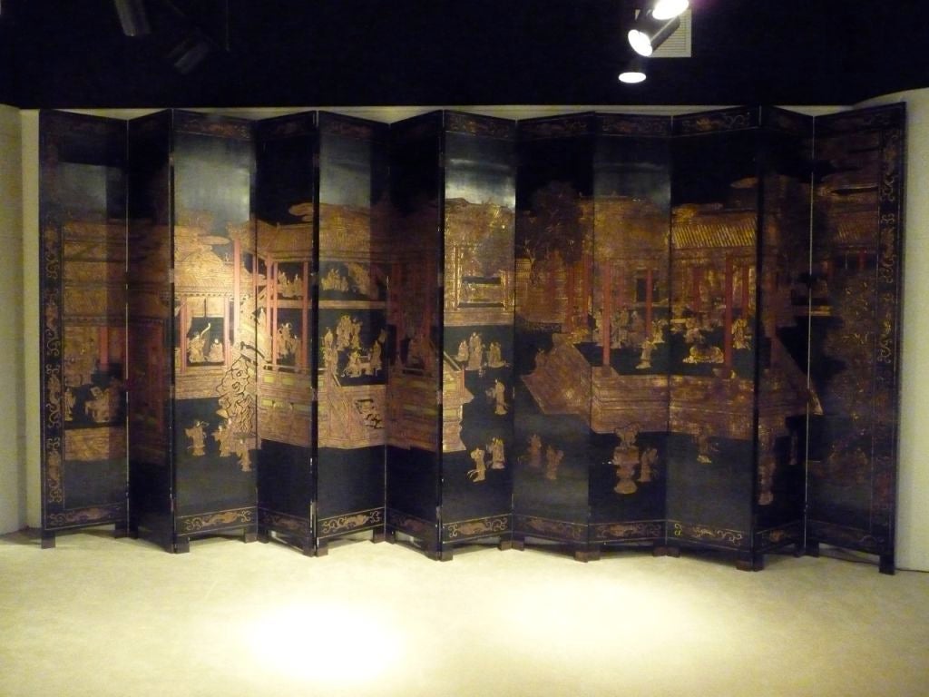 Large 12 paneled Chinese screen with bracket feet and extensive detailing.