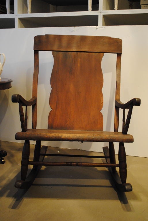 A rare and unusual large scale rocking chair retaining its original surface.