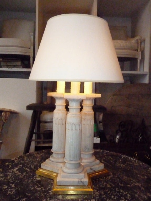 A three column carved marble neoclassical lamp on a new gilded wooden base. Newly electrified.