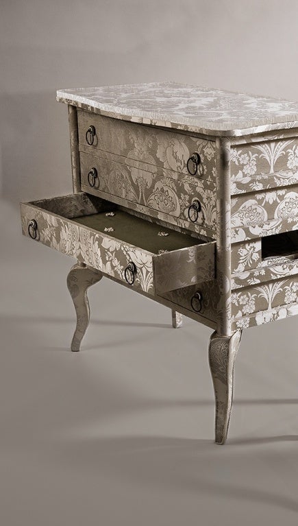 Based on an 18th century, Italian piece, the Venice commode is 100% upholstered with damask silk, inside and out. Its features include hand-tufted drawer interiors, handmade wrought iron ring hardware and an acrylic chipped edge top. Truly a work of
