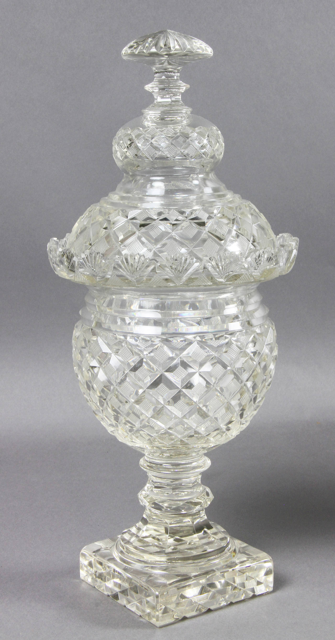 Each with a domed cover with  finial over a diamond cut bowl with a square foot.