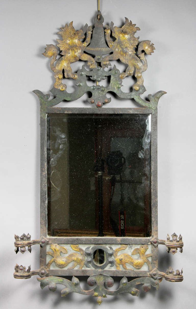 The crest with a pair of lions with crowns over a mirror plate over a lower section with animal and scroll decoration