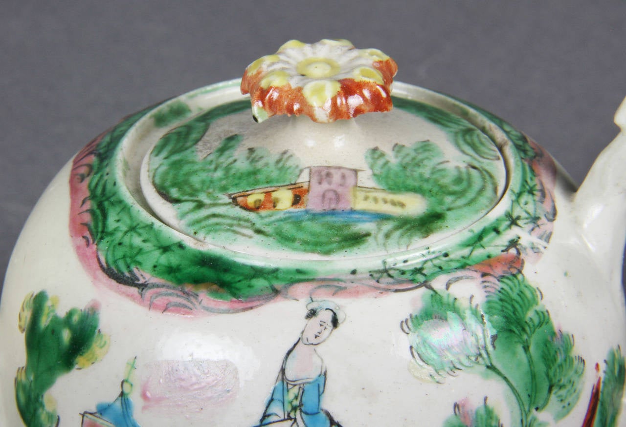 Round form with root form spout and handle , woman in landscape decoration , cover with floral finial.