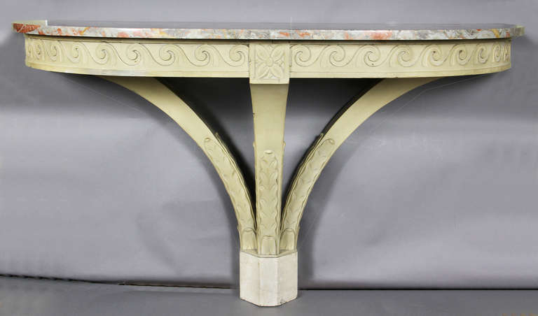 D shaped marble top over a frieze with vitruvian scroll and rosette design over a three leg support with terninating on a marble plinth.
