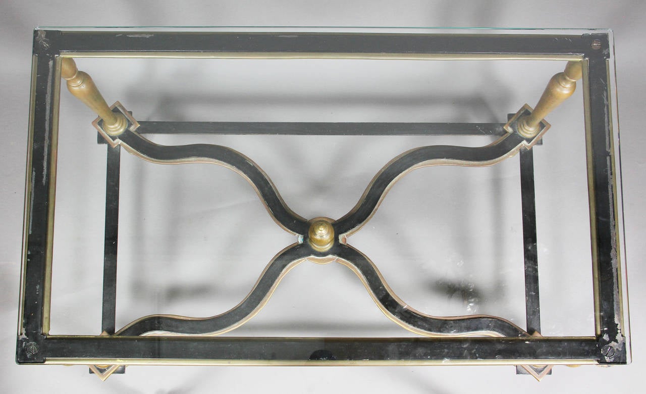Rectangular tempered glass top over turned tapered legs joined by shaped X-form stretcher with central finial, turned feet.