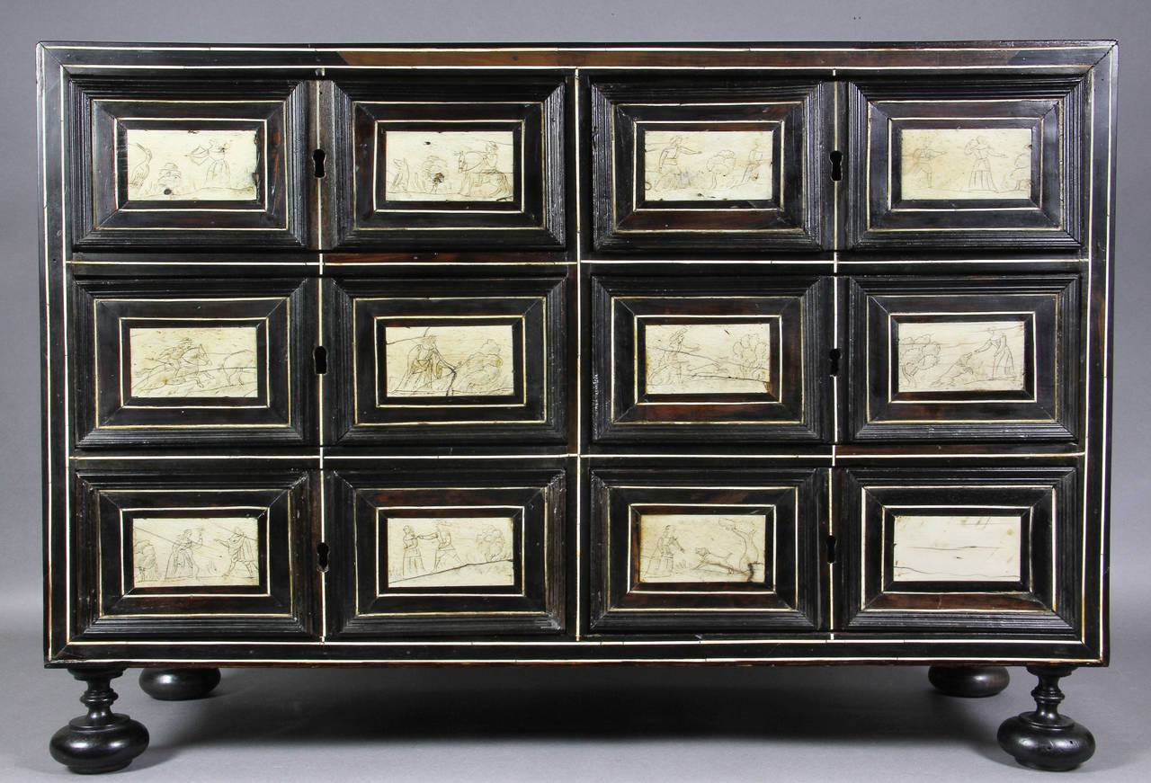 Rectangular rosewood panelled case and multiple drawers with scenes , bun feet.
