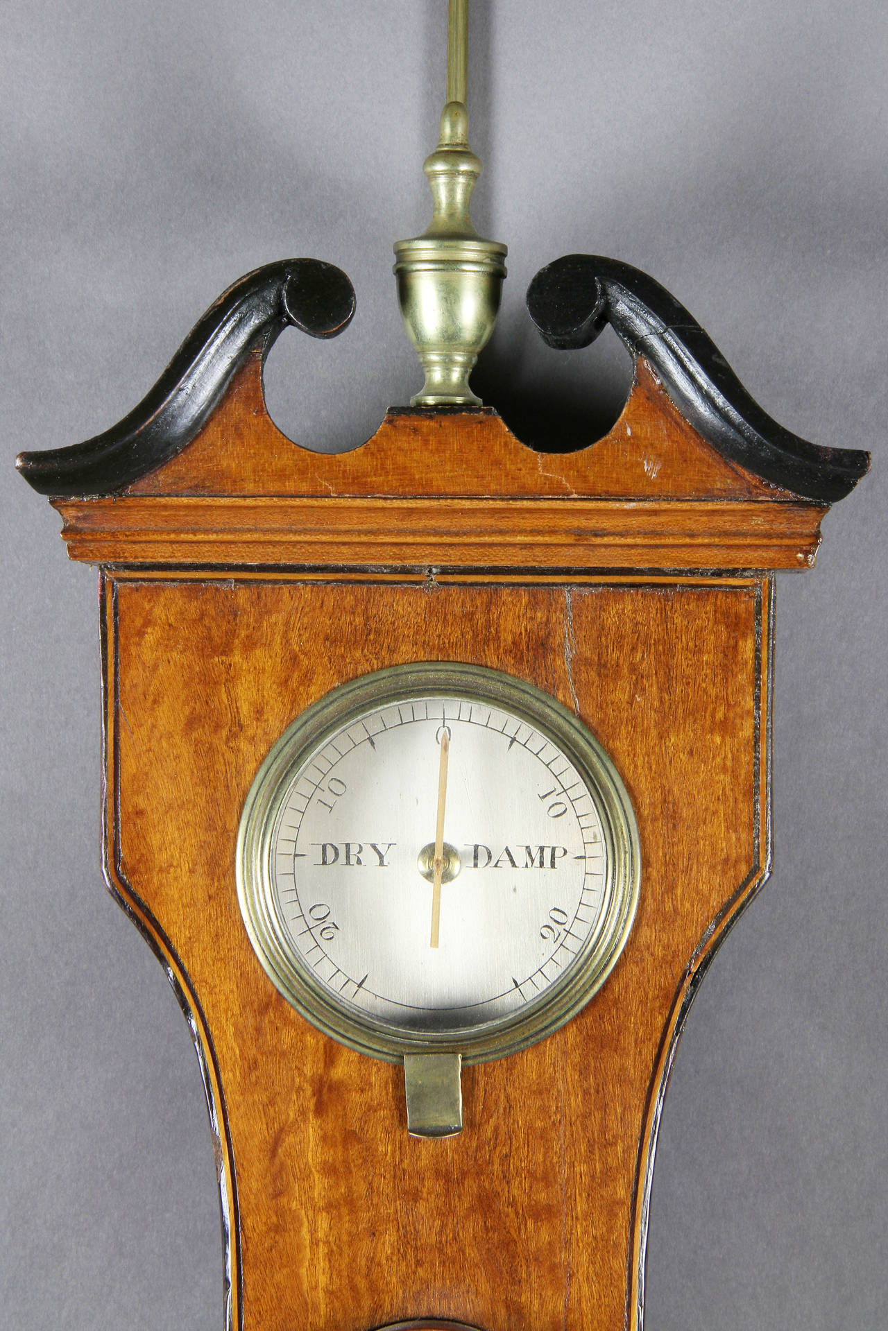 Typical form with scroll pediment over a hydrometer and a thermometer, a barometer dial and level by Del Vecchio, Dublin.