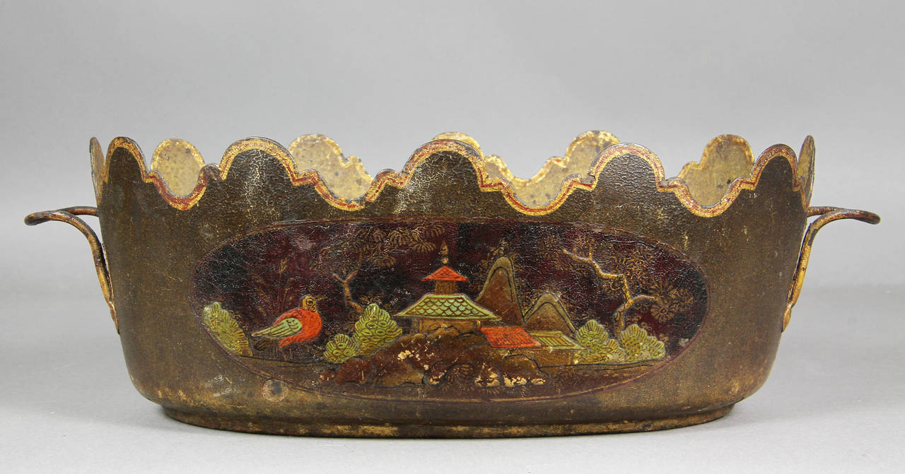 Typical form decorated in brown with chinoiserie scenes.