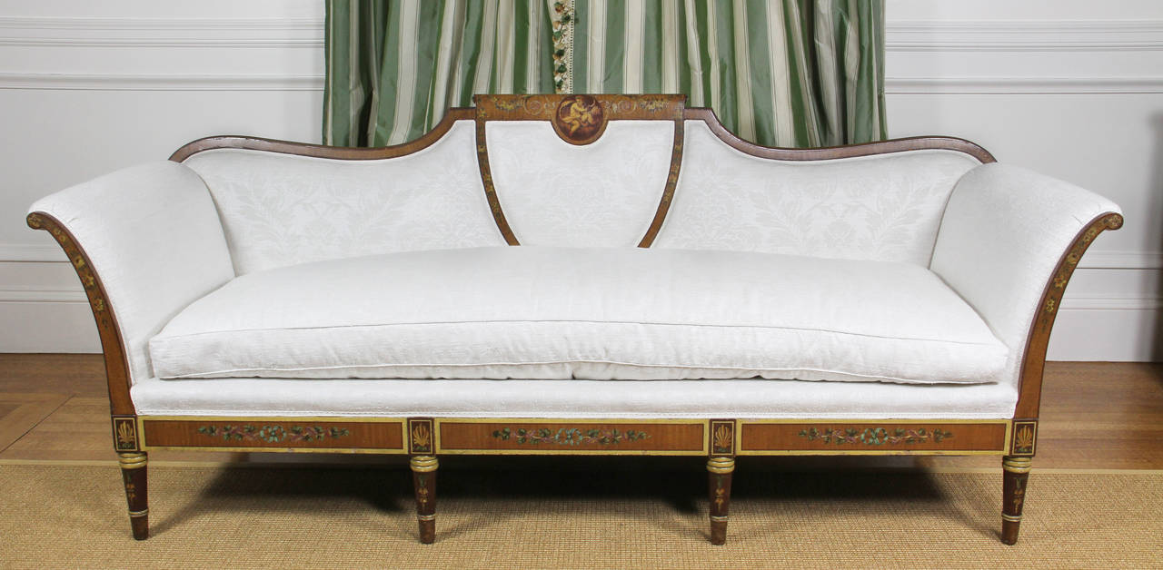 Upholstered in Pierre Frey damask in excellent condition. Finely painted decoration overall with central putti in roundel in center of top, circular tapered legs. Provenance: Wanamaker estate.