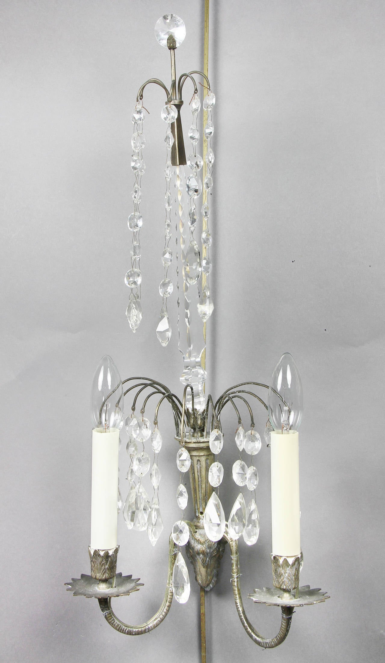 All with circular cut glass finial with a canopy of drops over two arms branching out from a rams head.