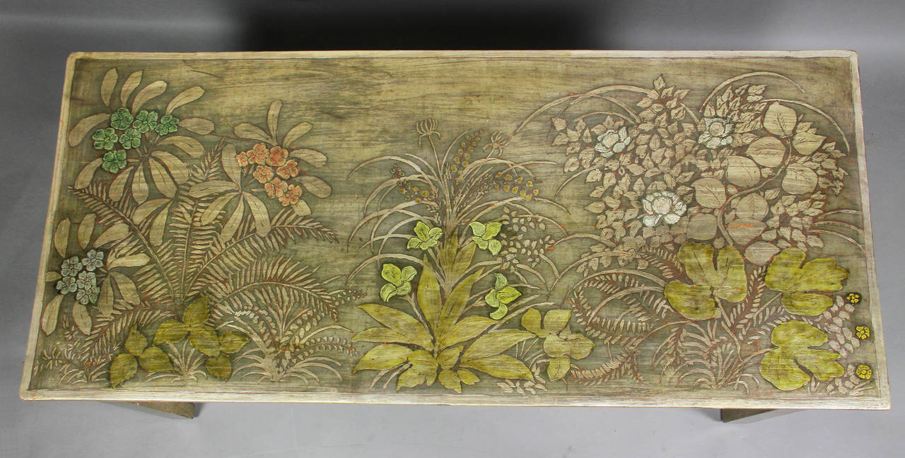 Rectangular top decorated with silver and gold painted decoration over gesso featuring ferns , flowers and leaves.