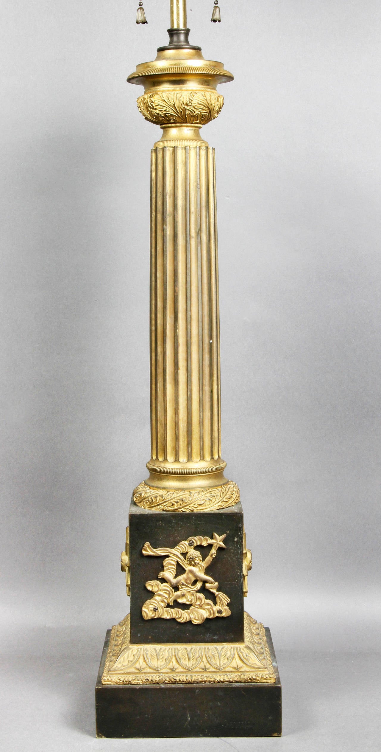 Nicely cast with reeded column, square plinth base with cherub in clouds holding a star.