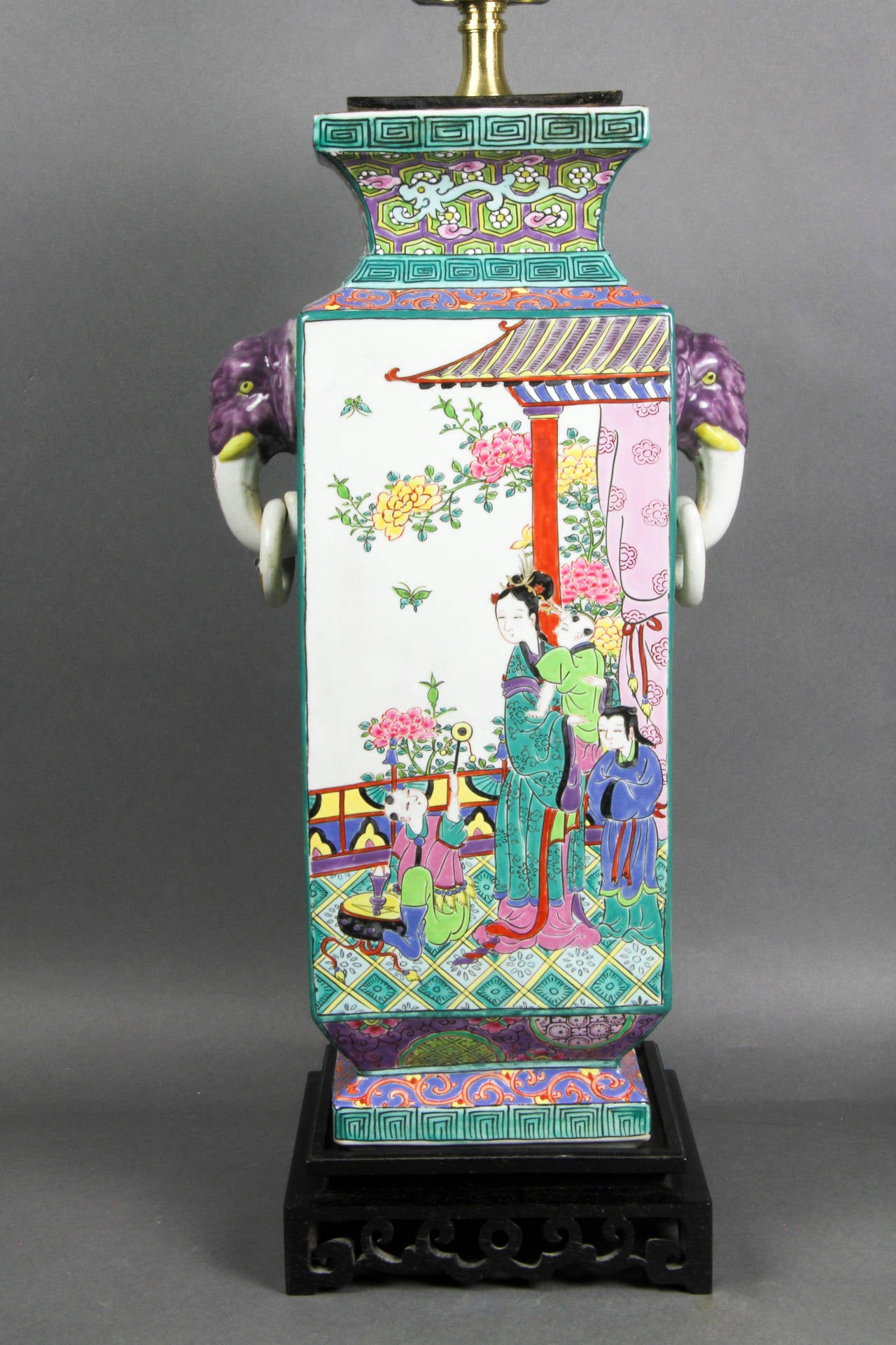 Beautifully painted with bright vibrant colors the square form vase with loose ring handles and elephant heads.