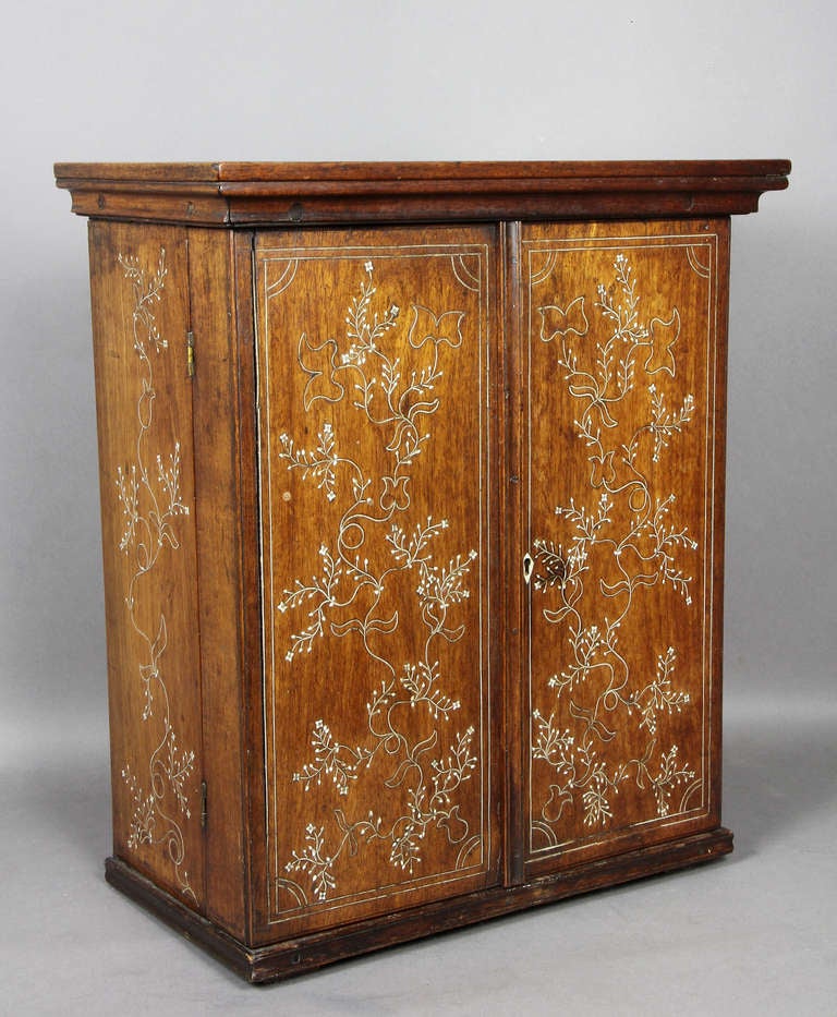 Cabinet with a pair of doors opening to a fitted interior.
