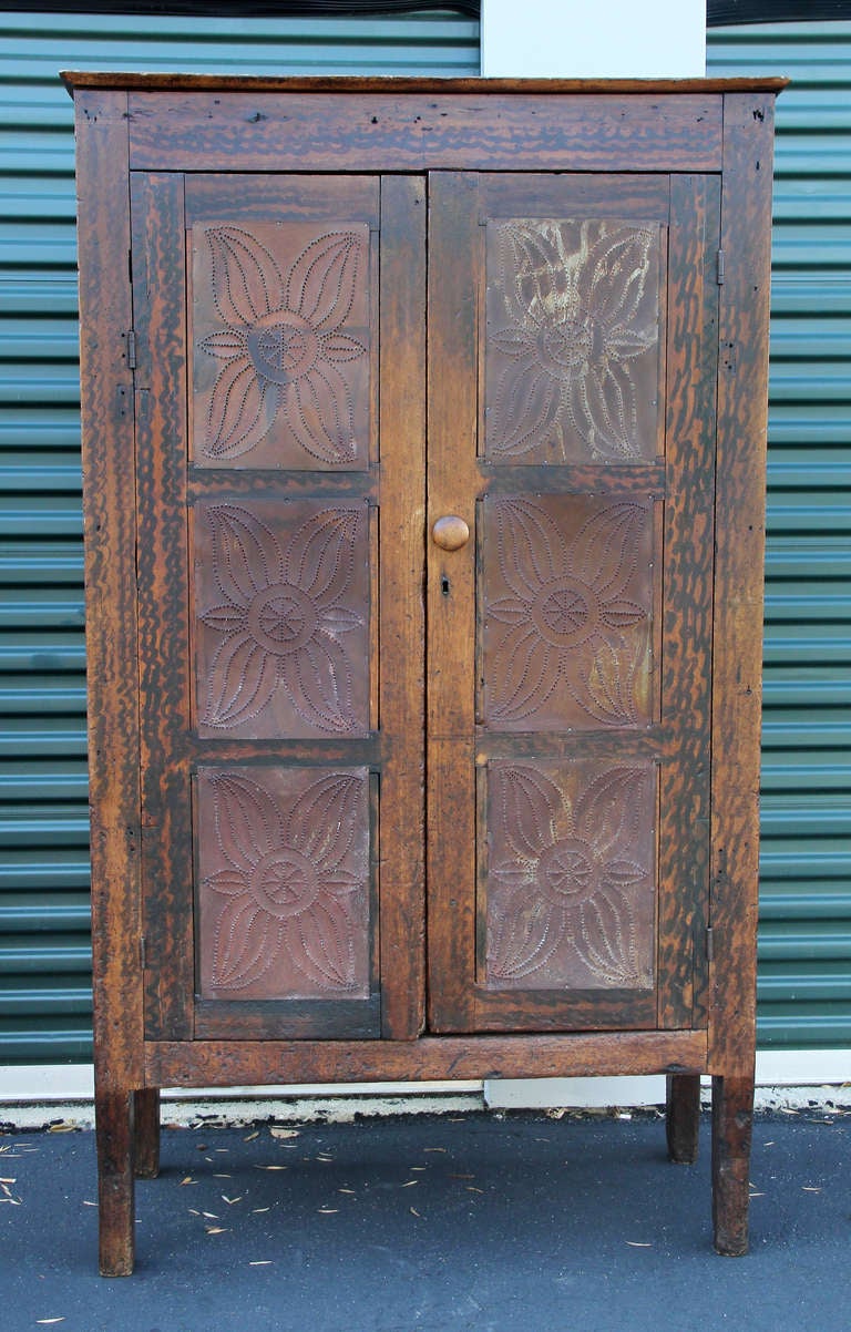 Pair of doors with pierced tin panels , square section legs.